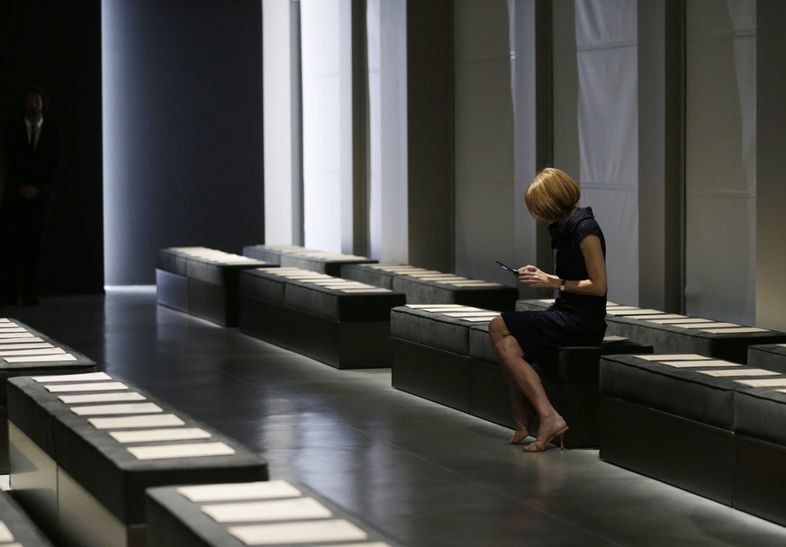 FILE - This is a Saturday, Sept. 22, 2012 file photo of Vogue editor in chief Anna Wintour checks her mobile phone prior to the start of the Bottega Veneta women&#039;s Spring-Summer 2013 show collect ...