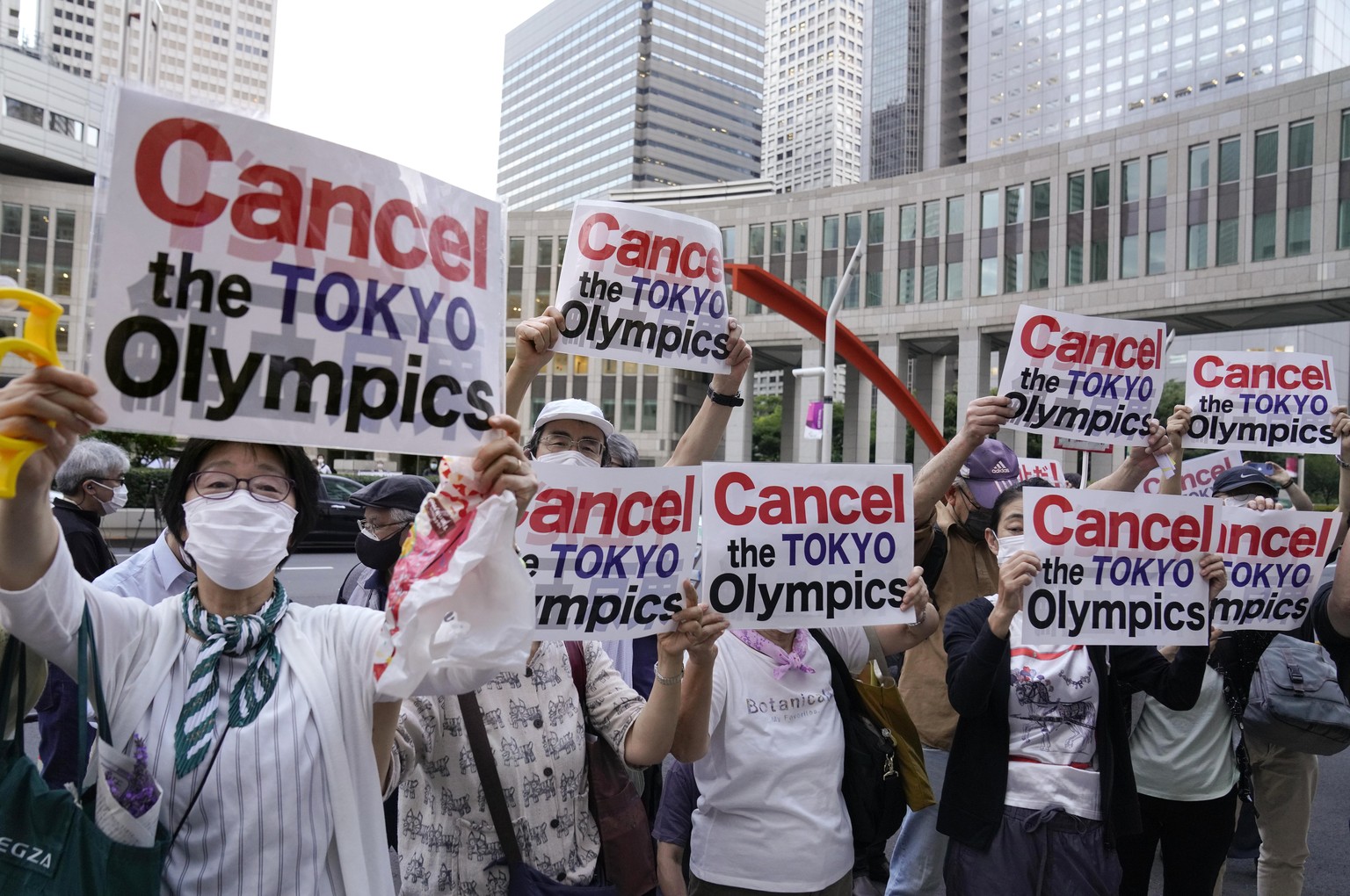 epa09295500 Demonstrators protest against Tokyo 2020 Olympic Games in front of Tokyo Metropolitan Government office building in Tokyo, Japan, 23 June 2021, one month before the opening of the Tokyo 20 ...