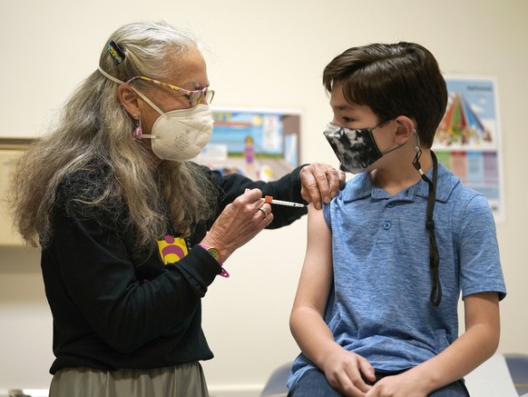 Dr. Kathy Merritt vaccinates 8 year-old Daniel McCullock with the Pfizer child COVID-19 vaccination at Chapel Hill Pediatrics and Adolescents in Chapel Hill, N.C., Thursday, Nov. 4, 2021. (AP Photo/Ge ...