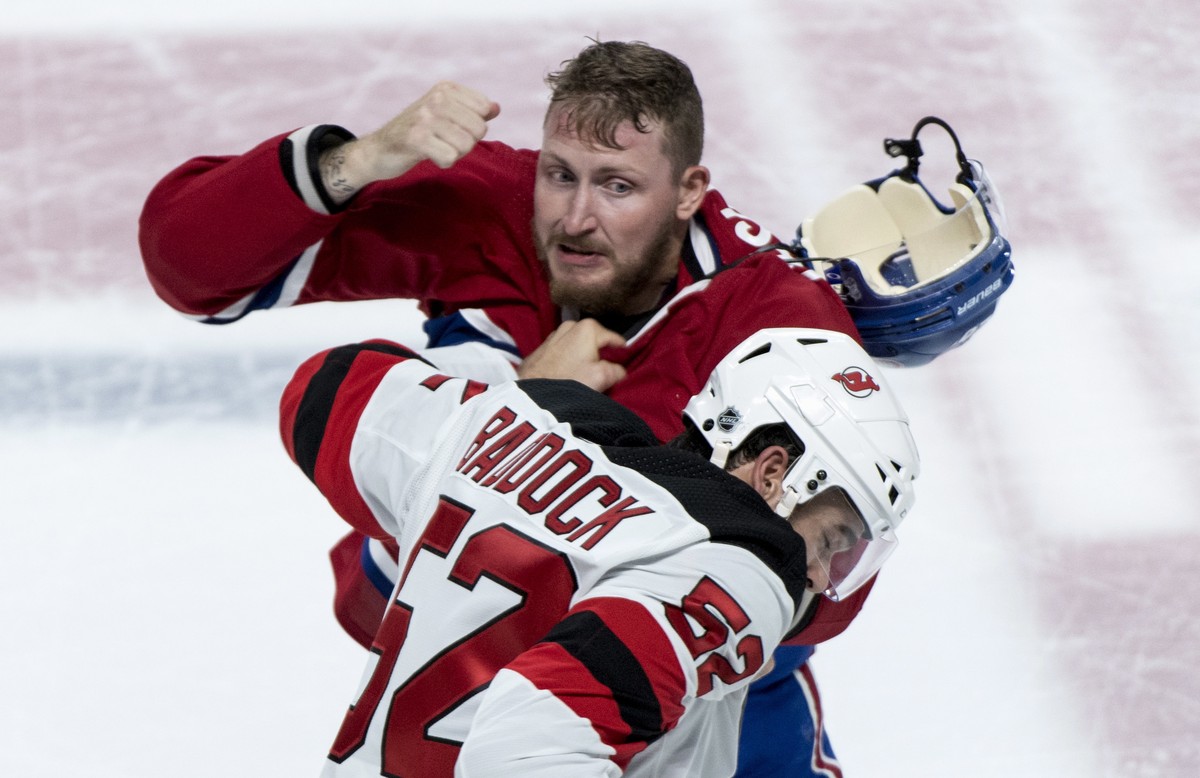 Montreal Canadiens' Nicolas Deslauriers, top, and New Jersey Devils' Brandon Baddock square off during first-period preseason NHL hockey game action Monday, Sept. 17, 2018, in Montreal. (Pau ...