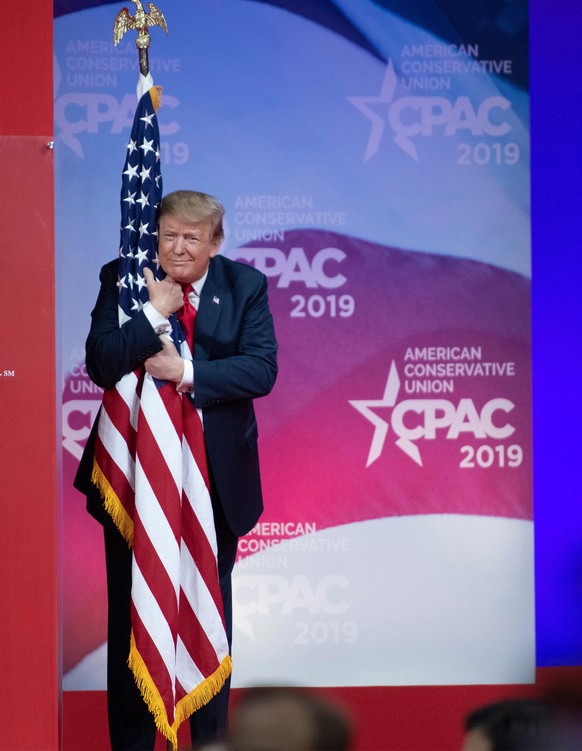 RESTRICTION: NO New York or New Jersey Newspapers or newspapers within a 75 mile radius of New York City
Mandatory Credit: Photo by REX/Shutterstock (10129689d)
Donald Trump hugs the American Flag as  ...