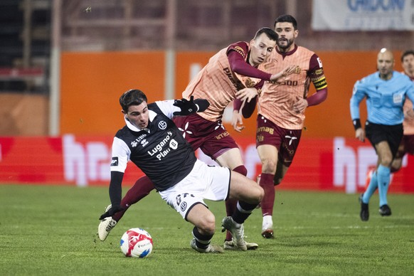 From left, Georgios Koutsias (LUG) and Loris Benito (YB), during the Super League soccer match FC Lugano against BSC Young Boys at the Cornaredo Stadium in Lugano, Sunday , 21 December, 2025. (KEYSTON ...