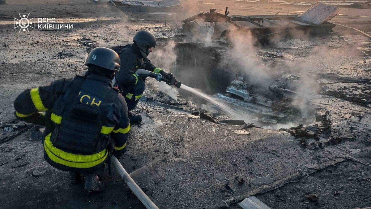In this photo provided by the Ukrainian Emergency Services on Wednesday, April 15, 2026, rescue workers put out a fire of building damaged after a Russian drone strike on Kyiv region, Ukraine. (Ukrain ...
