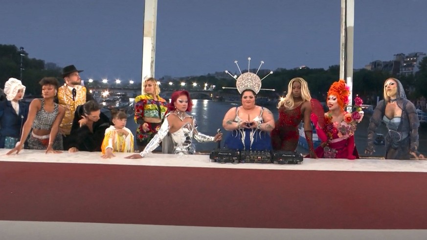 Parody of the Last Supper with DJ Leslie Barbara Butch and a dozen draq queens around the table during the opening ceremony of the 2024 Olympic Games JO 2024
