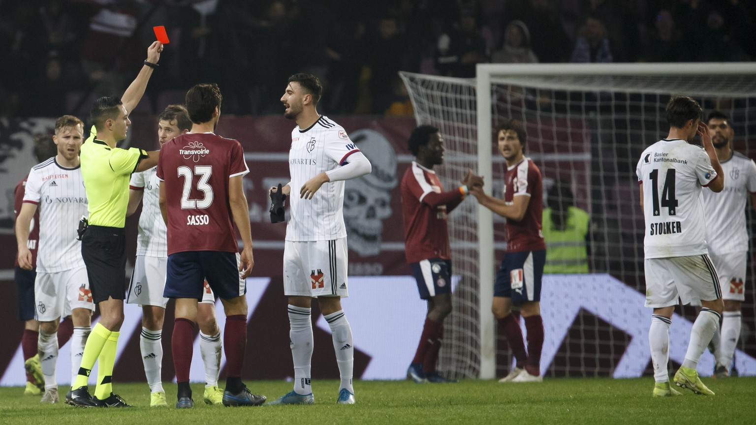 Referee Karim Abed the red card to Basel&#039;s players forward Kemal Ademi, 4th left, and Basel&#039;s midfielder Valentin Stocker #14, during the Super League soccer match of Swiss Championship betw ...