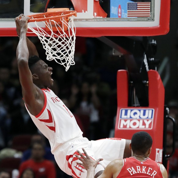 Houston Rockets center Clint Capela, top, reacts after dunking during the second half of an NBA basketball game against the Chicago Bulls, Saturday, Nov. 3, 2018, in Chicago. (AP Photo/Nam Y. Huh)