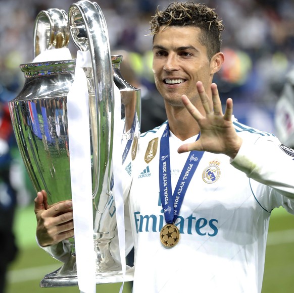 FILE - In this Saturday, May 26, 2018 file photo Real Madrid&#039;s Cristiano Ronaldo celebrates with the trophy after winning the Champions League Final soccer match between Real Madrid and Liverpool ...