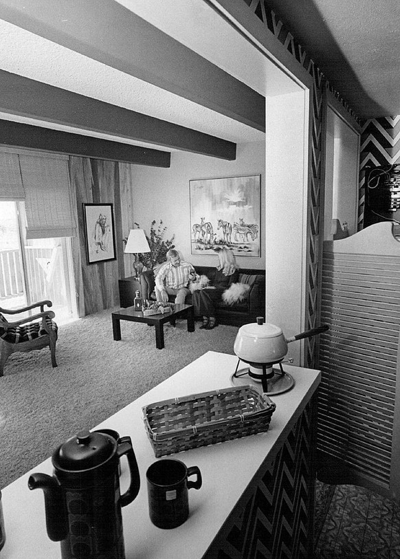 OCT 6 1971, OCT 13 1971, OCT 17 1971; Models John Karlson and Jannie Tucker sit on sofa in Darrel Howe-designed in terior. Living room's in tones of orange, yellow.; (Photo By Bill Johnson/The De ...