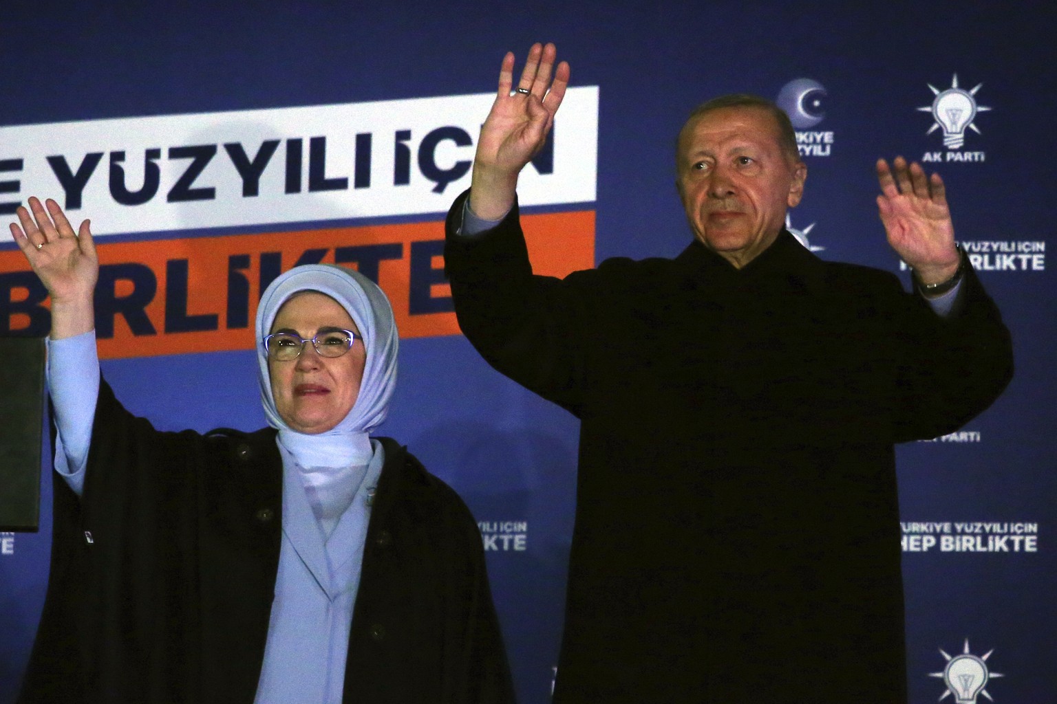 Turkish President Recep Tayyip Erdogan, right, and his wife Emine gesture to supporters at the party headquarters, in Ankara, Turkey, early Monday, May 15, 2023. Erdogan, who has ruled his country wit ...