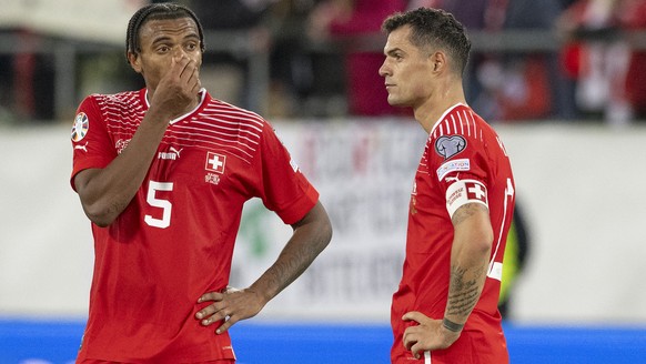 Switzerland&#039;s defender Manuel Akanji, left, and Switzerland&#039;s midfielder Granit Xhaka react during the UEFA Euro 2024 qualifying group I soccer match between Switzerland and Belarus, on Sund ...