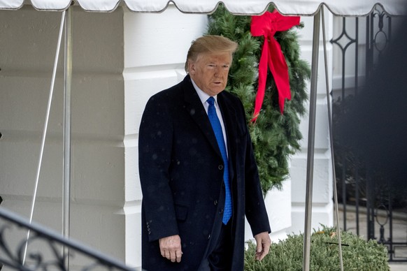 President Donald Trump walks towards members of the media before boarding Marine One on the south Lawn of the White House in Washington, Monday, Dec. 2, 2019, for a short trip to Andrews Air Force Bas ...