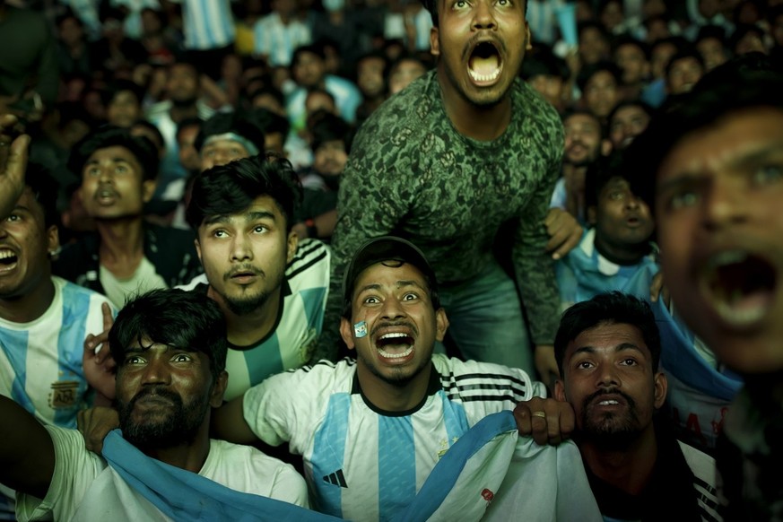 In the Dhaka University area of ​​Bangladesh, people gather to watch the FIFA World Cup Qatar 2022 match between Argentina and Poland on a big screen on the street on December 1, 2022.  While Argentina scores...