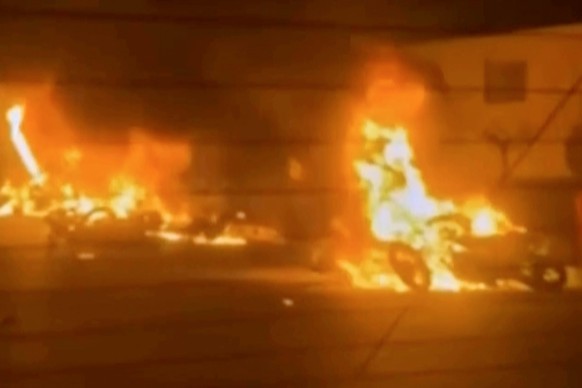 This frame grab from a video released by Iran state TV shows vehicles burning amid night of mass protests in Tehran, Iran, Thursday, Jan. 8, 2026. (Iran state TV via AP).Iran Protests