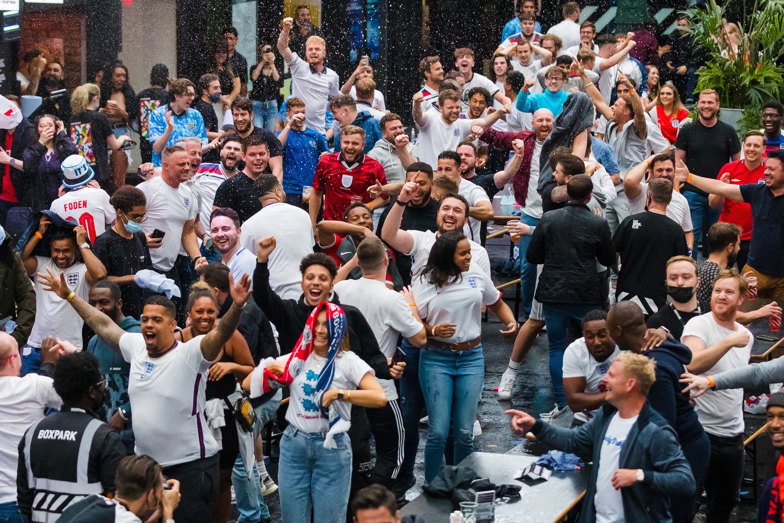 epa09311786 England supporters react when England scores a goal as they watch a public viewing of the UEFA EURO 2020 soccer match between England and Germany, in Boxpark, Croydon, London, Britain, 29  ...