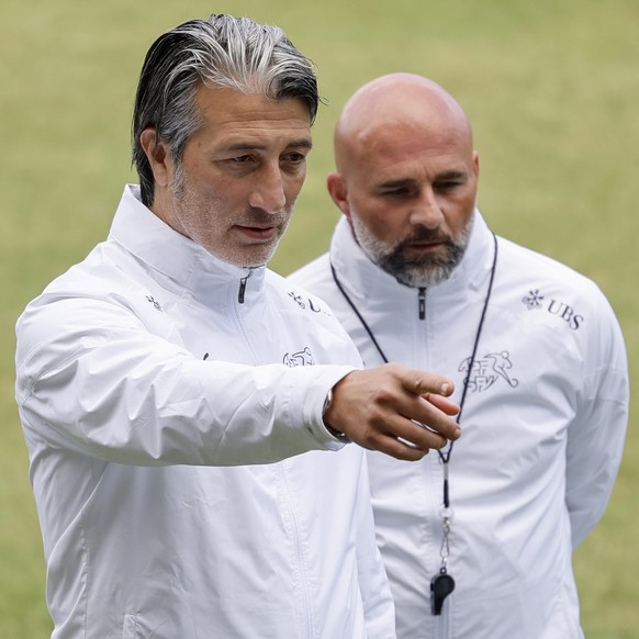 Switzerland&#039;s head coach Murat Yakin, left, and assistant coach Giorgio Contini discuss during a training session at the &quot;Stadion auf der Waldau&quot; in Stuttgart, Germany, Wednesday, June  ...