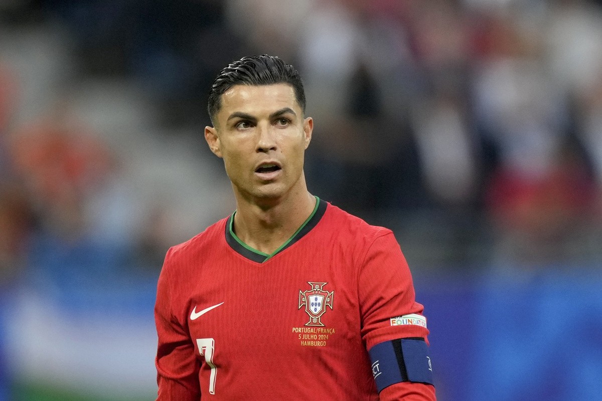 Portugal's Cristiano Ronaldo walks on the pitch during a quarter final match between Portugal and France at the Euro 2024 soccer tournament in Hamburg, Germany, Friday, July 5, 2024. (AP Photo/Ma ...