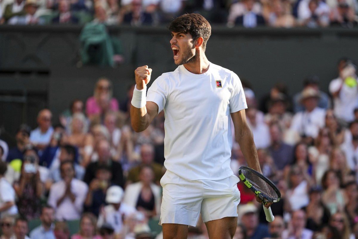 Spain's Carlos Alcaraz celebrates after beating Britain's Cameron Norrie during a quarterfinal men's singles match at the Wimbledon Tennis Championships in London, Tuesday, July 8, 2025 ...