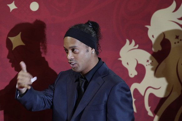 Brazilian soccer star and former FC Barcelona player Ronaldinho arrives for the the 2018 soccer World Cup draw in the Kremlin in Moscow, Friday, Dec. 1, 2017. (AP Photo/Dmitri Lovetsky)