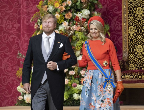 epa09479155 Dutch King Willem-Alexander (L) is flanked by Queen Maxima (R) after reading the Speech from the Throne on Budget Day, or Prinsjesdag, to members of the Senate and House of Representatives ...