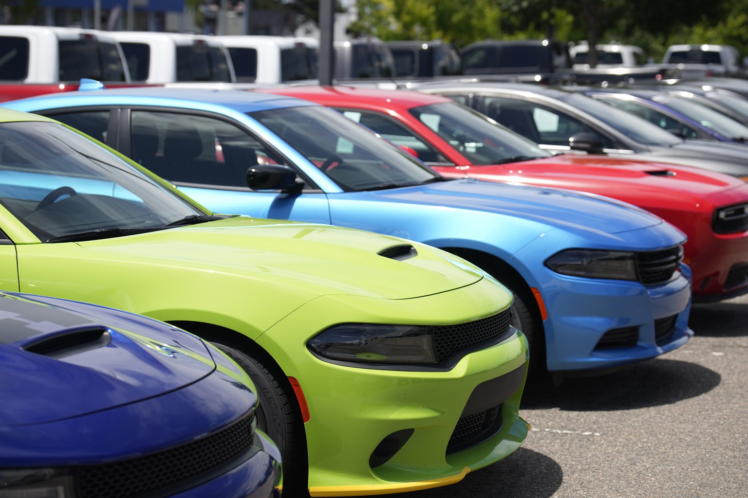 File - Unsold 2023 Charger sedans and Challenger hardtops sit at a Dodge dealership on June 18, 2023, in Littleton, Colo. Undeterred by high prices, rising interest rates, autoworker strikes and a com ...