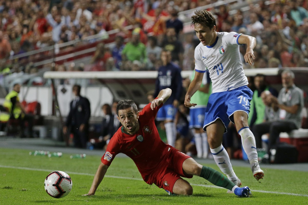 Portugal's Bernardo Silva, left, falls in front of Italy's Federico Chiesa during the UEFA Nations League soccer match between Portugal and Italy at the Luz stadium in Lisbon, Monday, Sept.  ...
