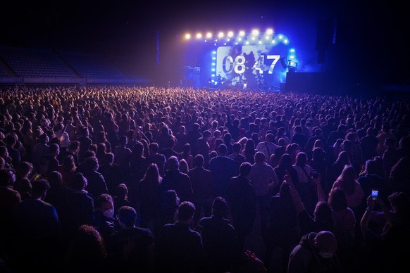 People attend a music concert in Barcelona, Spain, Saturday, March 27, 2021. Five thousand music lovers are set to attend a rock concert in Barcelona on Saturday after passing a same-day COVID-19 scre ...