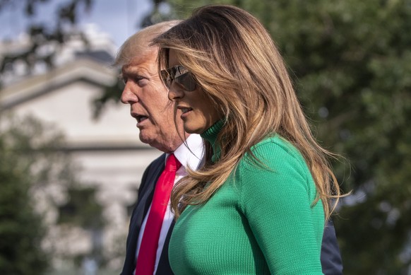 President Donald Trump and first lady Melania Trump arrive at the White House in Washington, Sunday, Aug. 19, 2018, after spending the weekend at his golf club in Bedminster, N.J. (AP Photo/J. Scott A ...