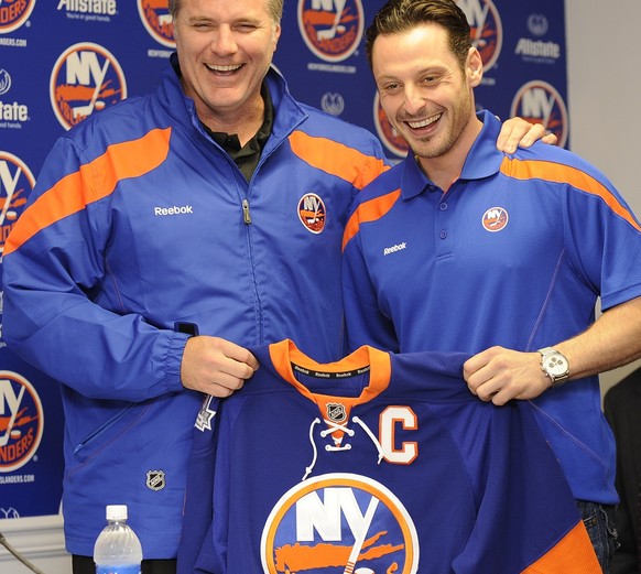 New York Islanders general manager Garth Snow, left, and newly-named captain Mark Streit smile during a news conference at NHL hockey training camp at Nassau Coliseum in Uniondale, N.Y., Wednesday, Se ...