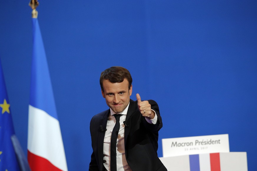 French centrist presidential candidate Emmanuel Macron thumbs up as he addresses his supporters at his election day headquarters in Paris , Sunday April 23, 2017. Macron and far-right populist Marine  ...