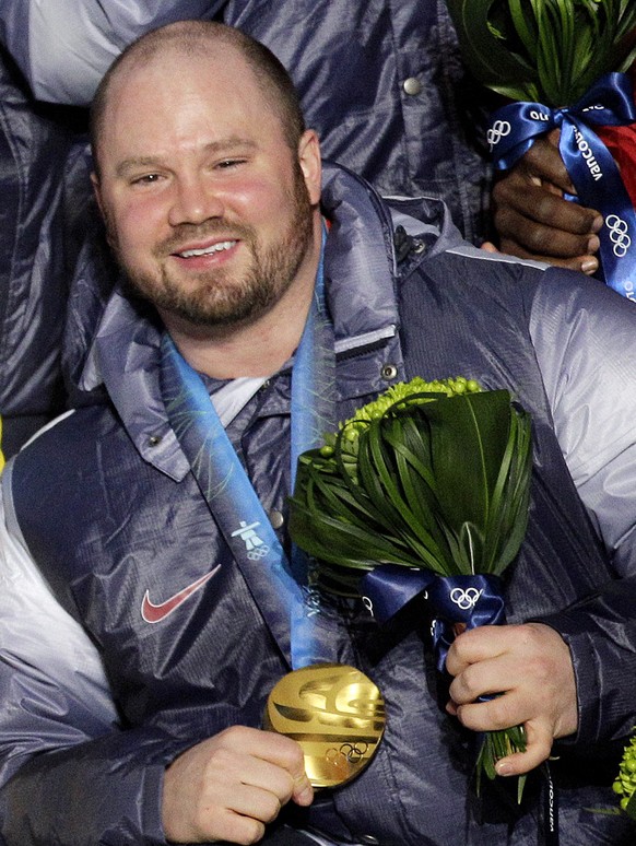 FILE - In this Feb. 27, 2010, file photo, Steven Holcomb, of the United States, poses with his gold medal in the men&#039;s four-man bobsled during the medal ceremony at the Vancouver 2010 Olympics in ...