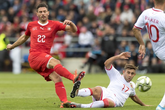 Switzerland&#039;s defender Fabian Schaer, left, fights for the ball with Gibraltar&#039;s midfielder Andrew Hernandez, right, during the UEFA Euro 2020 qualifying Group D soccer match between the Swi ...