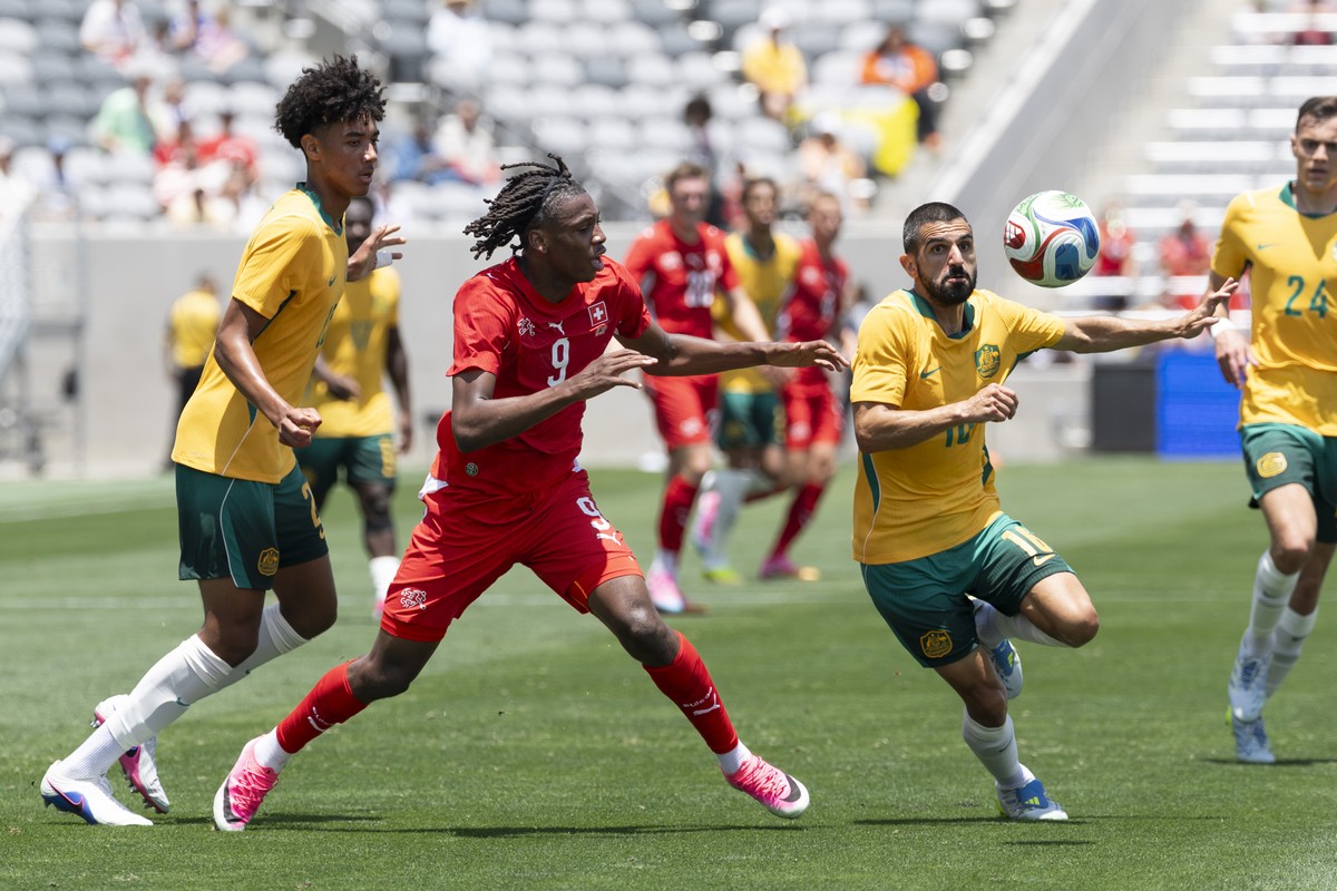 Australia's Lucas Herrington, Switzerland's Johan Manzambi and Australia's Aziz Behich, from left, in action during a friendly soccer match between Switzerland and Australia at the Snap ...