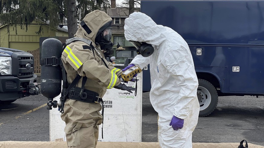 This photo provided by the Ohio National Guard, ONG 52nd Civil Support Team members prepare to enter an incident area to assess remaining hazards with a lightweight inflatable decontamination system ( ...