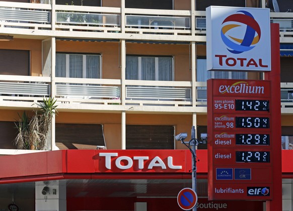 A logo is seen over prices at French oil and gas company Total gas station in Marseille, February 11, 2015. The French oil and gas company Total SA will present its 2014 annual results on Thursday. RE ...