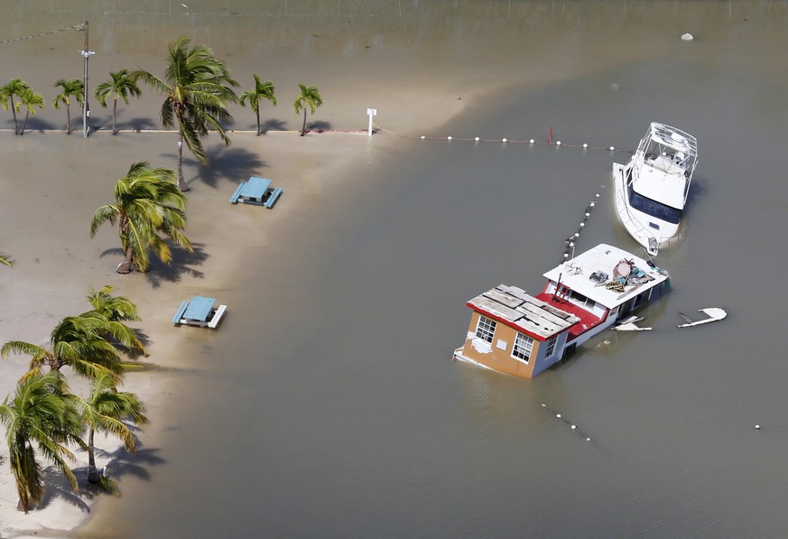 Boats are partially submerged in the wake of Hurricane Irma, Monday, Sept. 11, 2017, in Key Largo, Fla. (AP Photo/Wilfredo Lee)