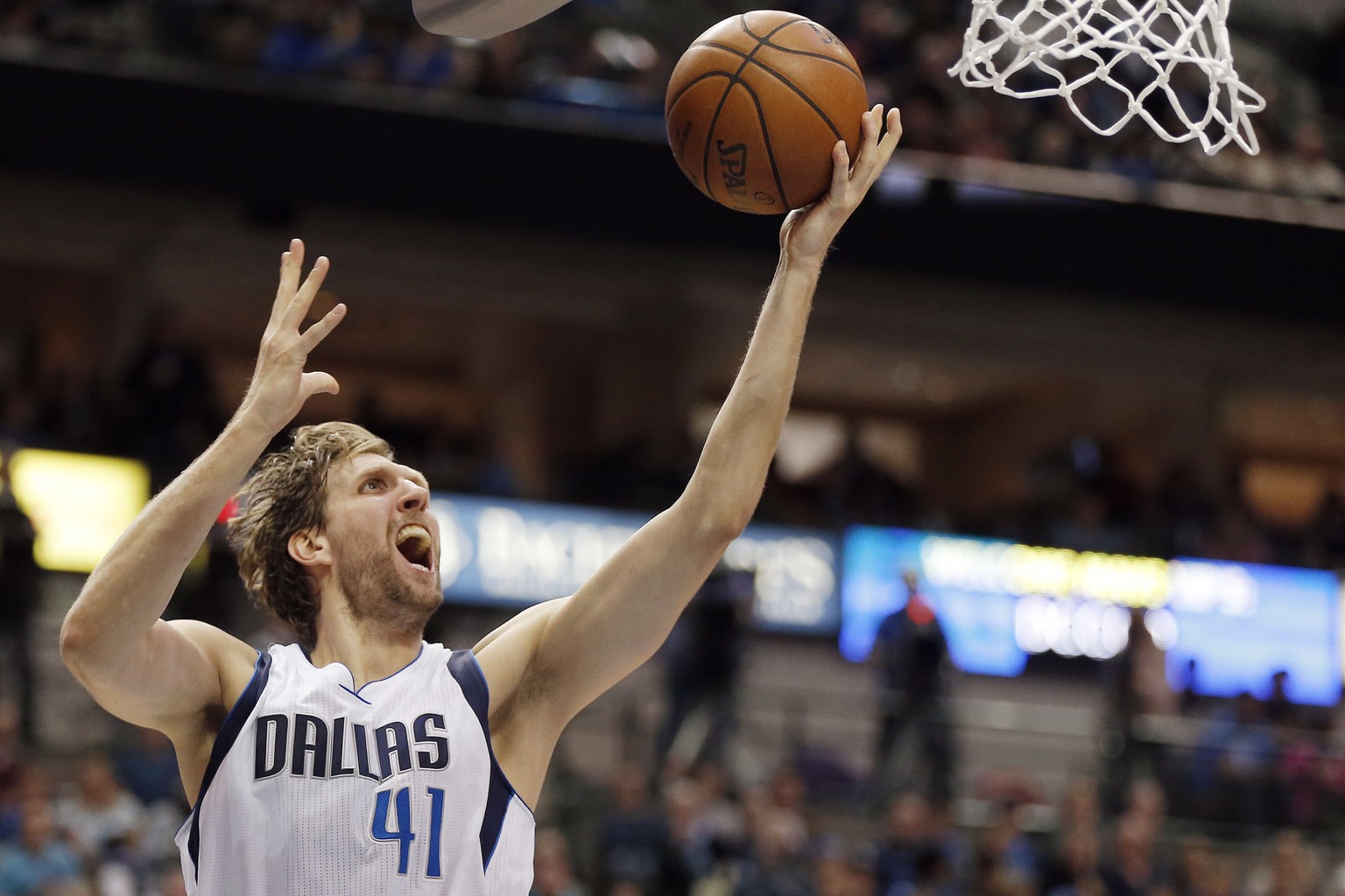 FILE - In this March 20, 2016, file photo, Dallas Mavericks forward Dirk Nowitzki (41) attempts a layup during the second half of an NBA basketball game against the Portland Trail Blazers in Dallas. N ...