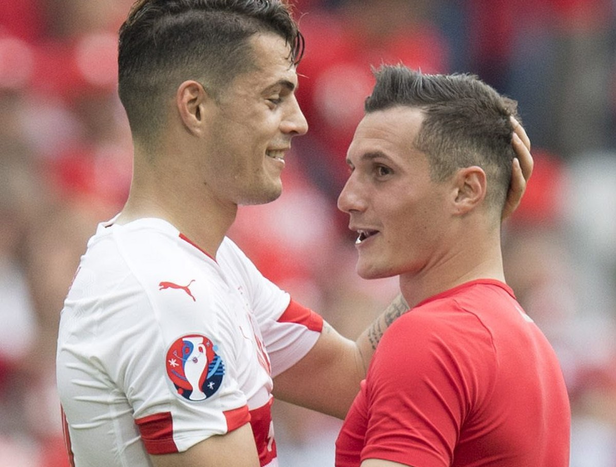 epa05357283 Swiss midfielder Granit Xhaka (L) cheers with his brother Albania's midfielder Taulant Xhaka after the UEFA EURO 2016 group A preliminary round match between Albania and Switzerland a ...