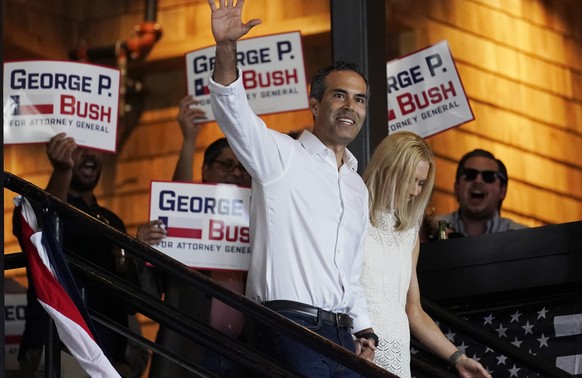 Texas Land Commissioner George P. Bush arrives for a kick-off rally with his wife Amanda to announced he will run for Texas Attorney General, Wednesday, June 2, 2021, in Austin, Texas. (AP Photo/Eric  ...