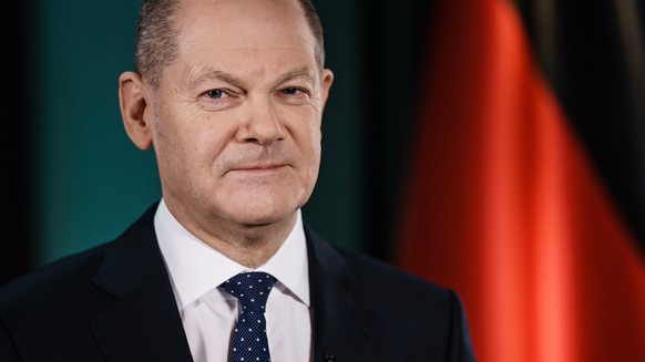 epa09660601 ATTENTION EDITORS: EMBARGO until 31 December 00:00 AM..German Chancellor Olaf Scholz poses for photographs after the television recording of his first New Year&#039;s speech at the chancel ...