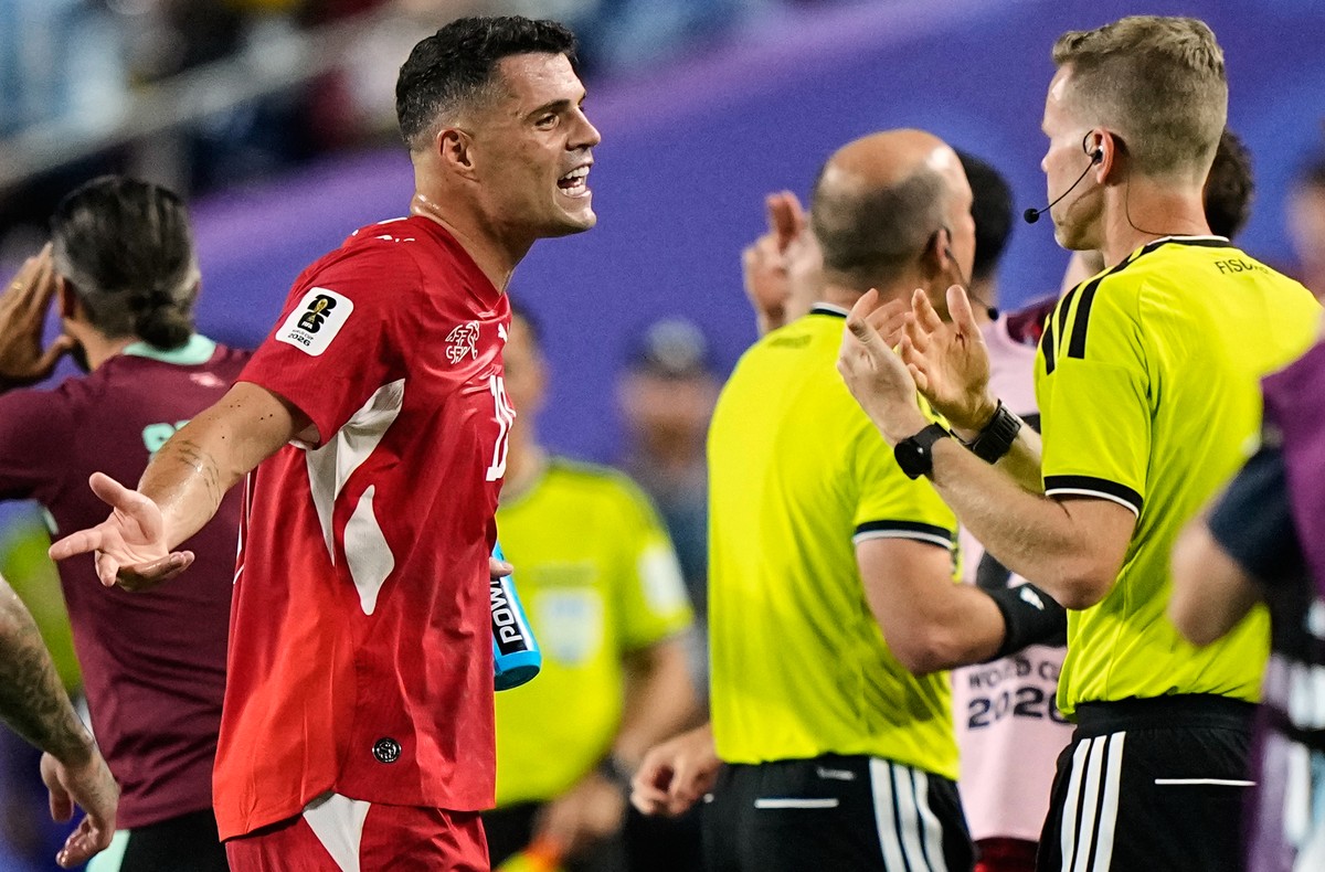 Switzerland's Granit Xhaka, left, argues a call by match officials during the World Cup quarterfinal soccer match against Argentina in Kansas City, Mo., Saturday, July 11, 2026. (AP Photo/Charlie ...