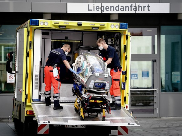 Sanit�ter vom Bundeswehr Rettungsdienst bringen die Spezialtrage, mit der Nawalny in die Charite eingeliefert wurde, zur�ck in den Krankenwagen. Foto: Kay Nietfeld/dpa