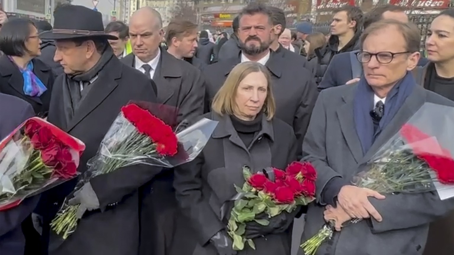In this photo taken from video released by Russian independent news outlet SOTAvision Telegram channel, U.S. Ambassador to Russia Lynne Tracy, centre, and Western diplomats wait outside the Church of  ...