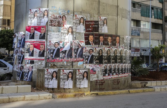 epa06647758 Posters depicting photos of candidates for Lebanese parliamentary elections from competing lists posted on a Beirut street, Lebanon 05 April 2018. A total of 976 candidates have presented  ...