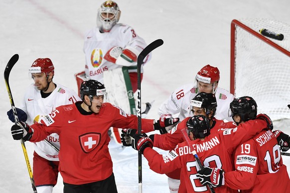 Switzerland’s Ramon Untersander, Thomas Ruefenacht, Simon Bodenmann and Reto Schaeppi, from left, celebrate their goal to 1:0 during their Ice Hockey World Championship group B preliminary round match ...