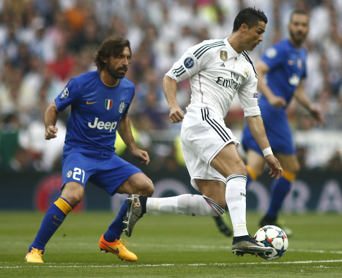 Real Madrid's Cristiano Ronaldo fights for the ball against Juventus' Andrea Pirlo during the Champions League second leg semifinal soccer match between Real Madrid and Juventus, at the Sant ...
