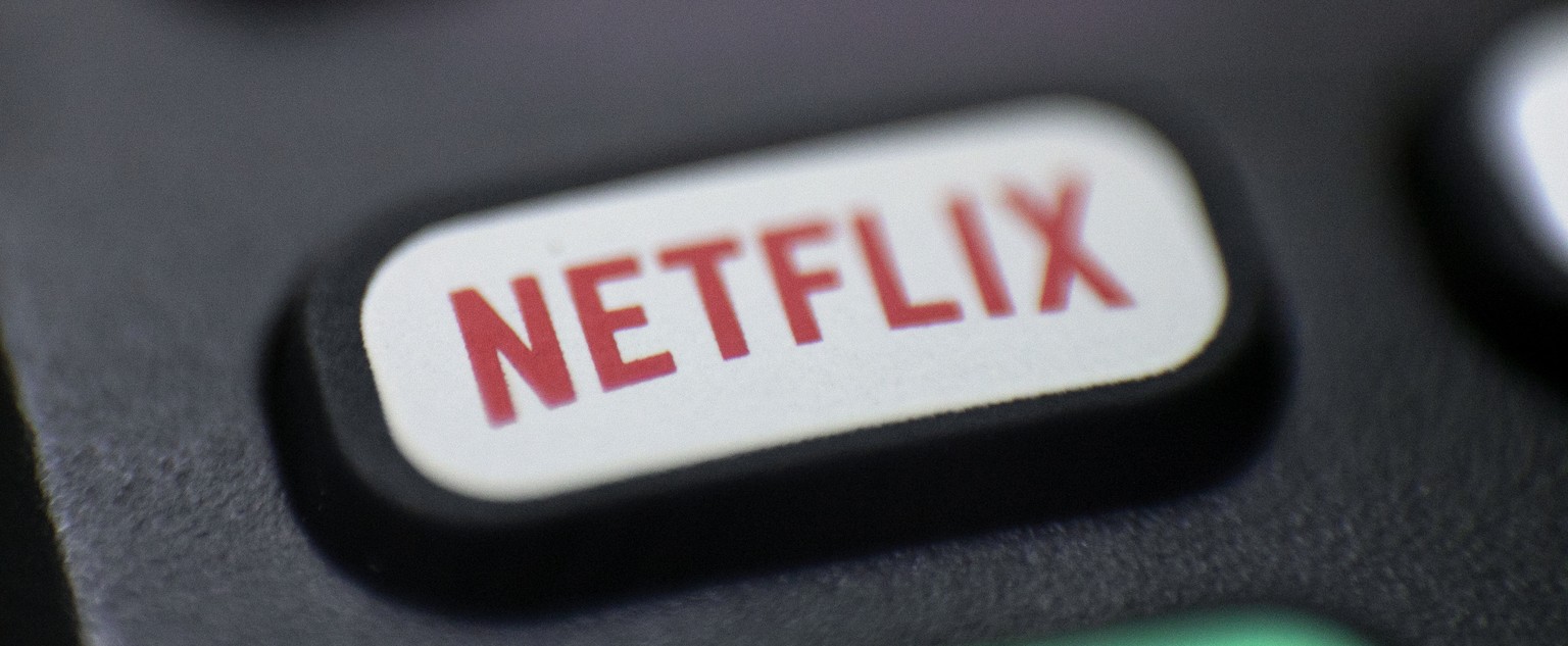 FILE - This Aug. 13, 2020 file photo shows a logo for Netflix on a remote control in Portland, Ore. Streaming services ranging from Netflix to Disney+ want us to stop sharing passwords. That&#039;s th ...