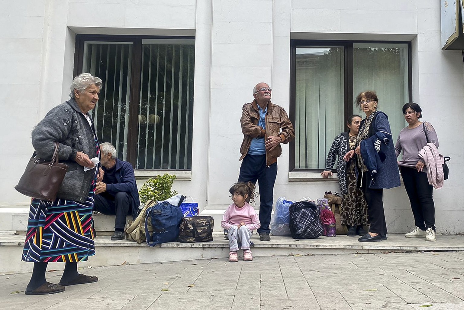 Local residents gather near a local government building after reports of shooting in Stepanakert, Nagorno-Karabakh on Thursday, Sept. 21, 2023. Azerbaijan President Ilham Aliyev declared victory in a  ...