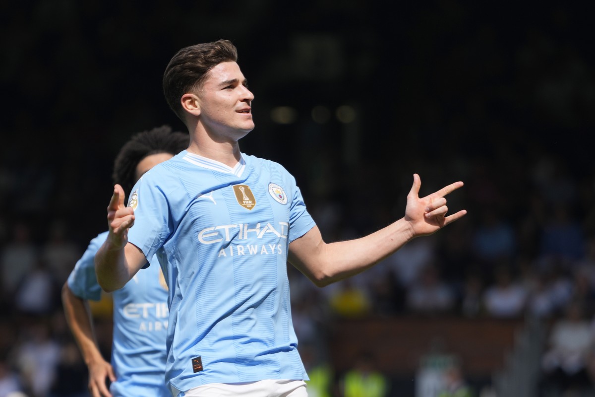 Manchester City's Julian Alvarez celebrates after scoring his side's fourth goal during the English Premier League soccer match between Fulham and Manchester City at the Craven Cottage Stadi ...