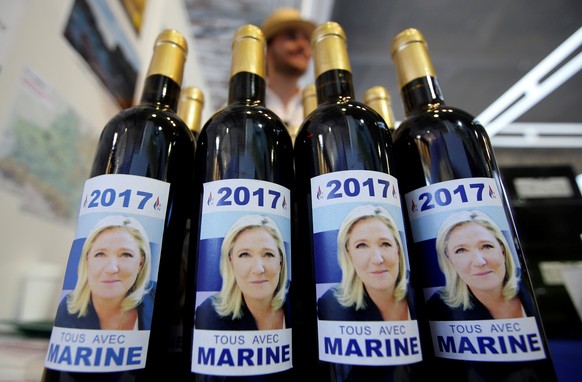 A supporter of French National Front (FN) political party leader Marine Le Pen sells bottles of wine during a FN political rally in Frejus, France September 18, 2016. REUTERS/Jean-Paul Pelissier