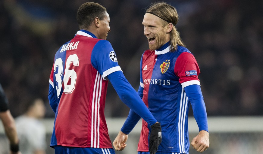 Basel&#039;s Michael Lang, right, reacts with Manuel Akanji after the UEFA Champions League Group stage Group A matchday 5 soccer match between Switzerland&#039;s FC Basel 1893 and England&#039;s Manc ...